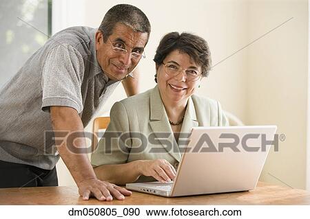 Portrait of mature couple with laptop View Large Photo Image Stock Image - Portrait of mature couple with laptop. Fotosearch