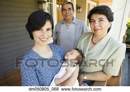Stock Photo - Portrait of mother with sleeping baby and grandparents. Fotosearch