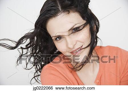 Stock Photograph - Portrait of woman with hair blowing. Fotosearch