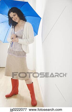 Portrait of woman with umbrella and rubber boots View Large Photo Image Stock Photo - Portrait of woman with umbrella and rubber boots. Fotosearch