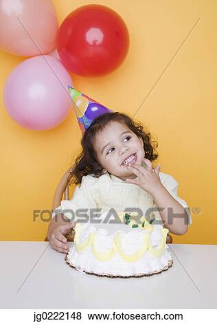 Stock Photo - Portrait of young girl with birthday cake. Fotosearch