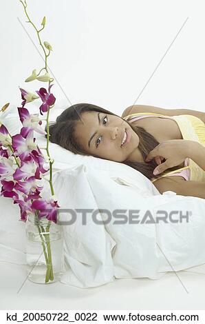 Teenage girl smiling for the camera in bed View Large Photo Image Stock Image - Teenage girl smiling for the camera in bed. Fotosearch