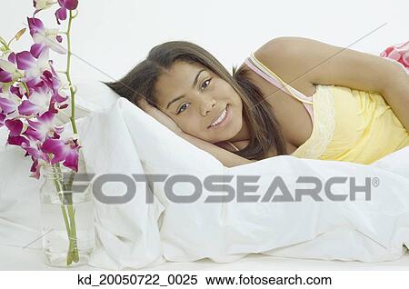 Teenage girl smiling for the camera in bed View Large Photo Image Stock Photography - Teenage girl smiling for the camera in bed. Fotosearch