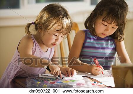 Stock Image - Two girls coloring. Fotosearch