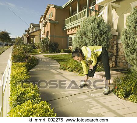 Stock Photography - Woman exercising in neighborhood. Fotosearch