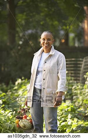 Woman standing in garden View Large Photo Image Stock Image - Woman standing in garden. Fotosearch