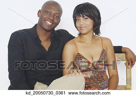 Young couple smiling for the camera View Large Photo Image Stock Image - Young couple smiling for the camera. Fotosearch