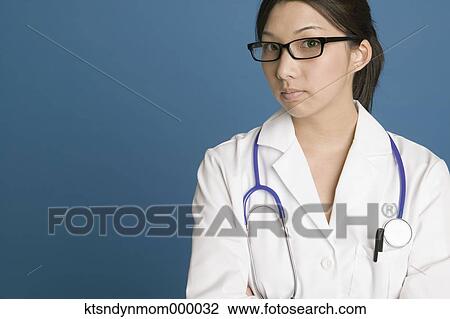 Young female doctor posing for the camera View Large Photo Image Stock Image - Young female doctor posing for the camera. Fotosearch