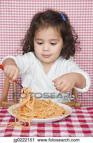 Young girl eating spaghetti View Large Photo Image Stock Image - Young girl eating spaghetti. Fotosearch