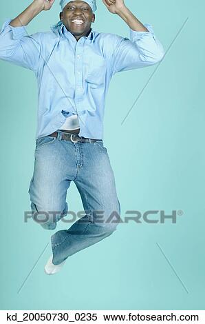 Young man jumping for joy View Large Photo Image Stock Photography - Young man jumping for joy. Fotosearch