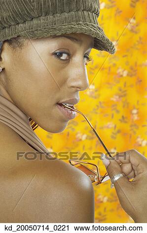 Stock Image - Young woman posing for the camera. Fotosearch