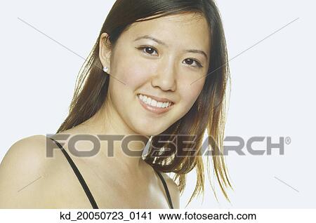 Stock Image - Young woman smiling for the camera. Fotosearch