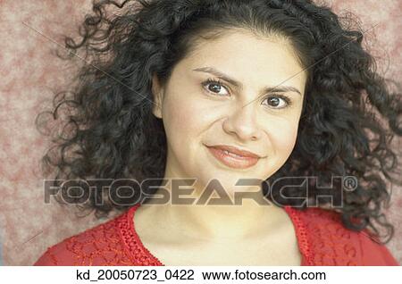 Stock Image - Young woman smiling for the camera. Fotosearch