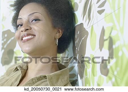 Stock Image - Young woman smiling for the camera. Fotosearch