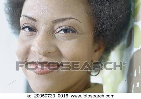 Young woman smiling for the camera View Large Photo Image Stock Photograph - Young woman smiling for the camera. Fotosearch