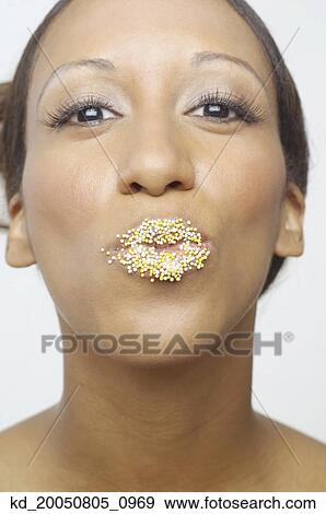 Stock Photo - Young woman with sprinkles on her lips. Fotosearch