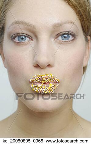Stock Photography - Young woman with sprinkles on her lips. Fotosearch