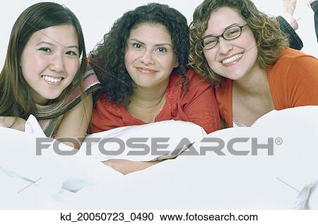 Young women smiling for the camera View Large Photo Image Stock Image - Young women smiling for the camera. Fotosearch