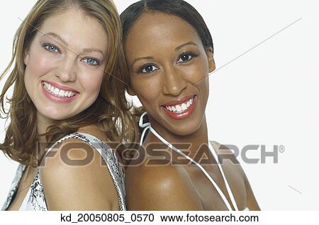 Young women smiling for the camera View Large Photo Image Stock Image - Young women smiling for the camera. Fotosearch