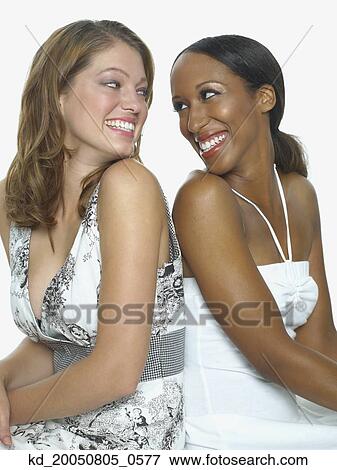 Stock Photo - Young women smiling for the camera. Fotosearch