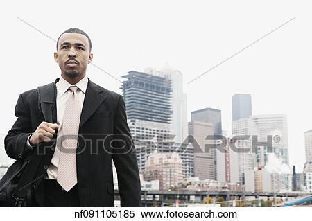 Businessman carrying a briefcase View Large Photo Image Stock Photography - Businessman carrying a briefcase. Fotosearch