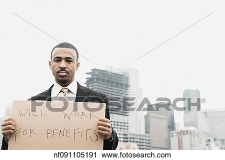 Businessman holding a sign proclaiming, ÏWill Work For BenefitsÓ View Large Photo Image Stock Image - Businessman holding a sign proclaiming, ÏWill Work For BenefitsÓ. Fotosearch
