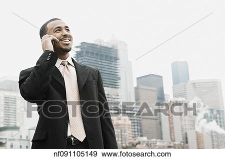 Businessman talking on his cell phone View Large Photo Image Stock Photo - Businessman talking on his cell phone. Fotosearch