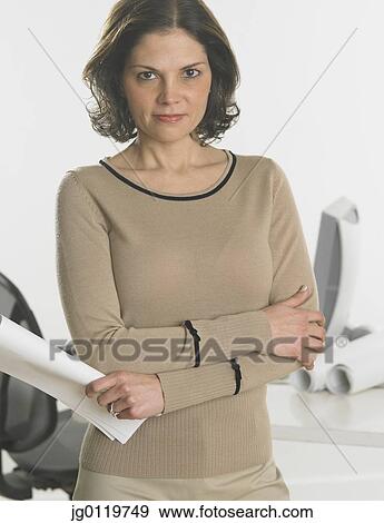 Stock Photo - Businesswoman holding papers. Fotosearch