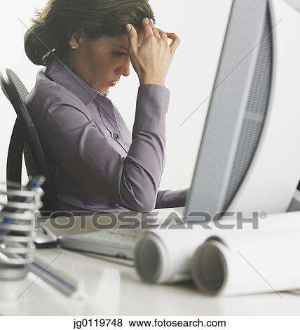 Businesswoman using a computer View Large Photo Image Stock Photo - Businesswoman using a computer. Fotosearch