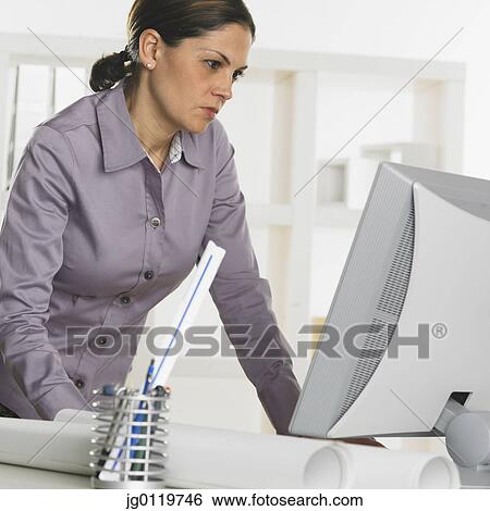 Businesswoman using a computer View Large Photo Image Stock Photograph - Businesswoman using a computer. Fotosearch