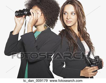 Businesswomen looking through binoculars View Large Photo Image Stock Photo - Businesswomen looking through binoculars. Fotosearch