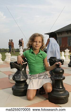 Children playing on life-size chess board View Large Photo Image Stock Photography - Children playing on life-size chess board. Fotosearch