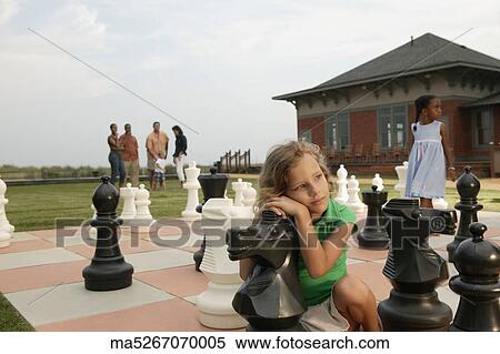 Children playing on life-size chess board View Large Photo Image Stock Photography - Children playing on life-size chess board. Fotosearch