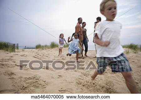 Children playing on the beach View Large Photo Image Stock Photography - Children playing on the beach. Fotosearch