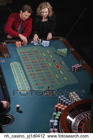 Stock Image - Couple gambling in a casino. Fotosearch