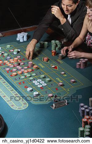 Couple gambling in a casino View Large Photo Image Stock Image - Couple gambling in a casino. Fotosearch