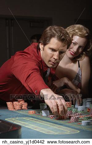 Stock Image - Couple gambling in a casino. Fotosearch