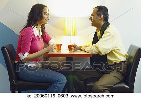 Couple having tea in a cafe View Large Photo Image Stock Image - Couple having tea in a cafe. Fotosearch