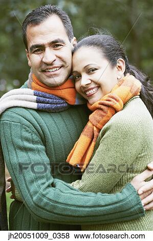 Couple hugging outdoors View Large Photo Image Stock Photo - Couple hugging outdoors. Fotosearch