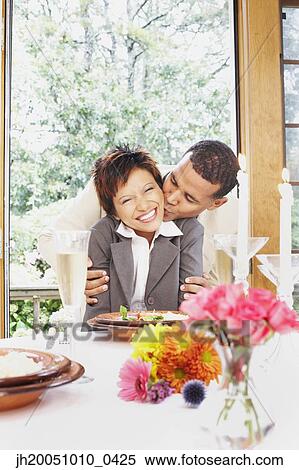 Couple kissing at the dinner table View Large Photo Image Stock Photography - Couple kissing at the dinner table. Fotosearch