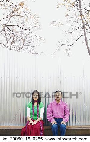 Stock Photography - Couple sitting on a bench together. Fotosearch