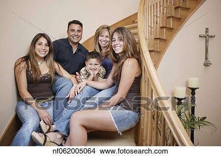 Picture - Family smiling for the camera together. Fotosearch