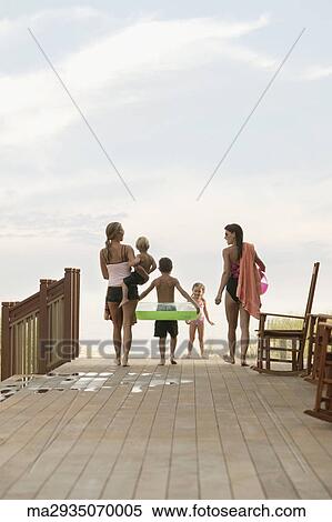 Stock Photography - Family walking towards the beach. Fotosearch