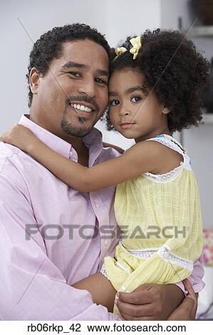 Stock Image - Father and daughter posing for the camera. Fotosearch
