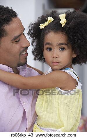 Stock Image - Father and daughter posing for the camera. Fotosearch