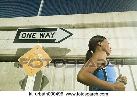 Female athlete running in urban surroundings View Large Photo Image Stock Photograph - Female athlete running in urban surroundings. Fotosearch