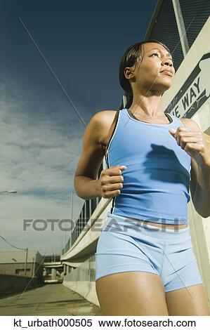 Female athlete running in urban surroundings View Large Photo Image Stock Photography - Female athlete running in urban surroundings. Fotosearch