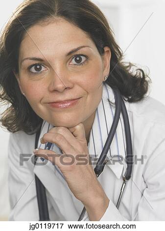 Female doctor smiling for the camera View Large Photo Image Stock Photo - Female doctor smiling for the camera. Fotosearch
