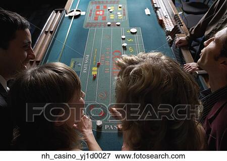 Friends gambling at a casino View Large Photo Image Stock Photo - Friends gambling at a casino. Fotosearch