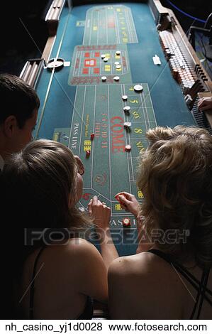 Friends gambling at a casino View Large Photo Image Stock Photo - Friends gambling at a casino. Fotosearch